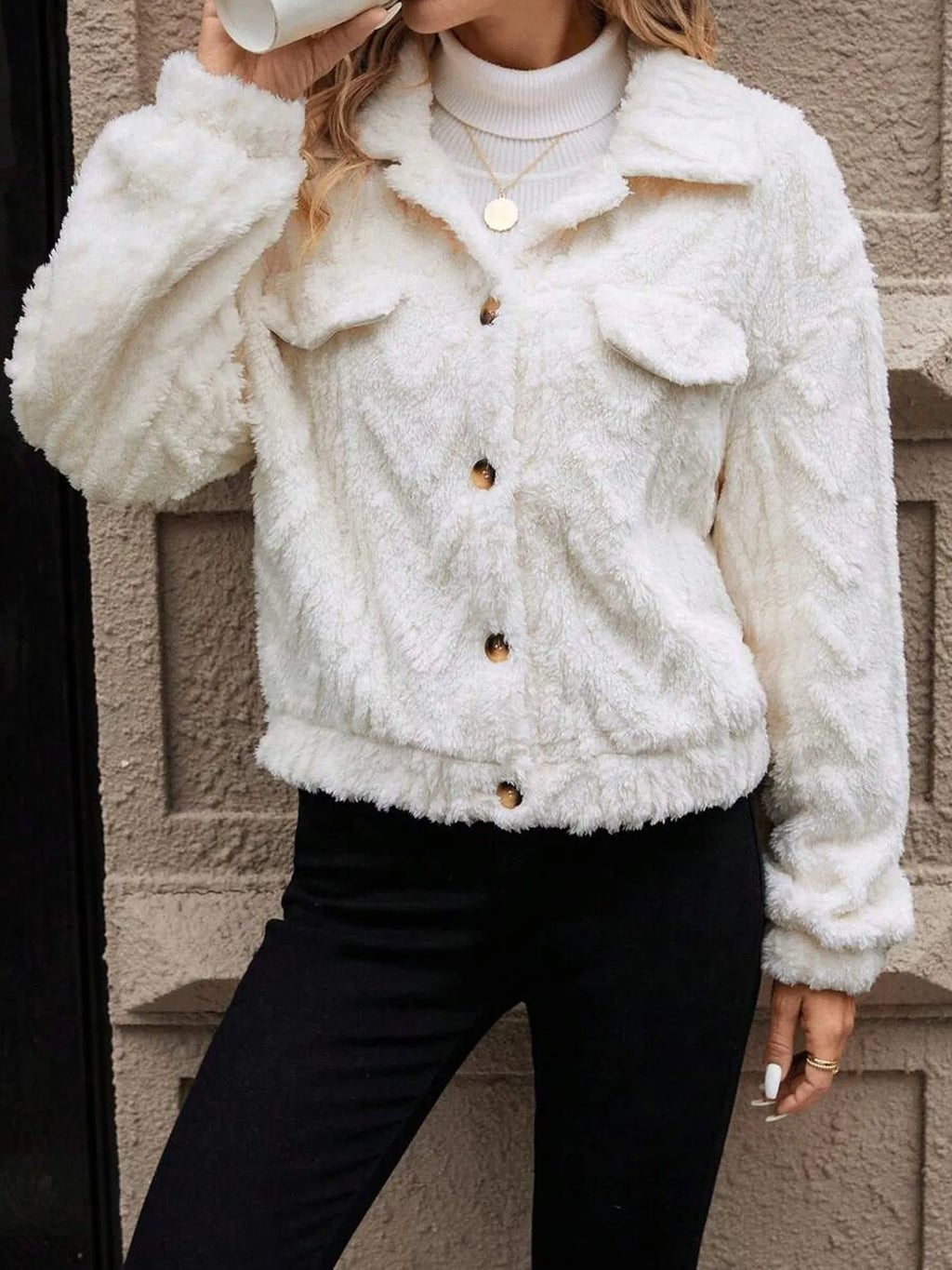 Ivory White women's plush button-front cardigan on a hanger