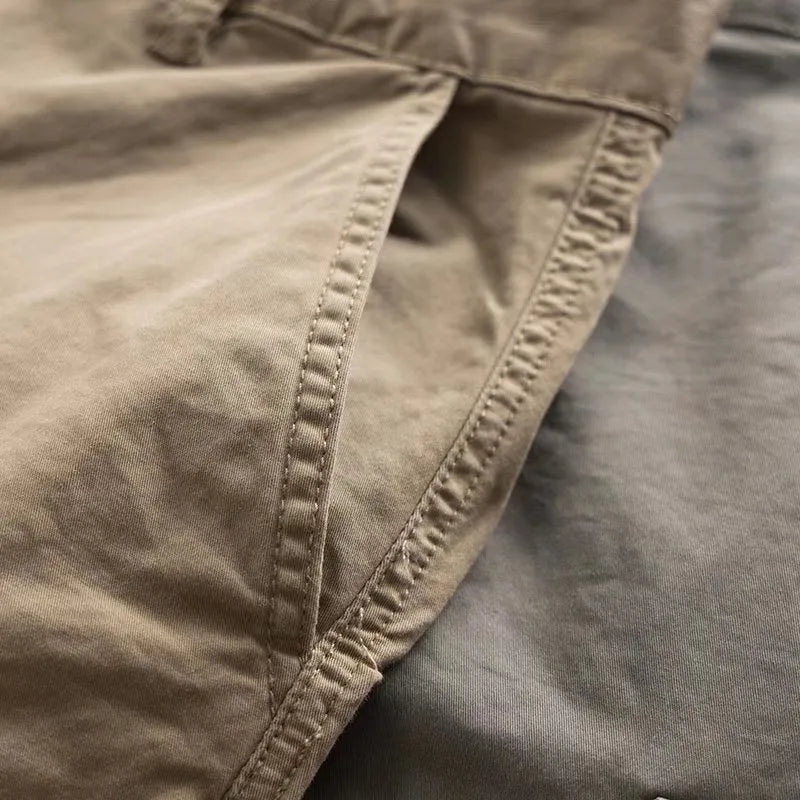 Men's multi-pocket cotton work trousers in khaki colour with cropped leg design showing utility pockets