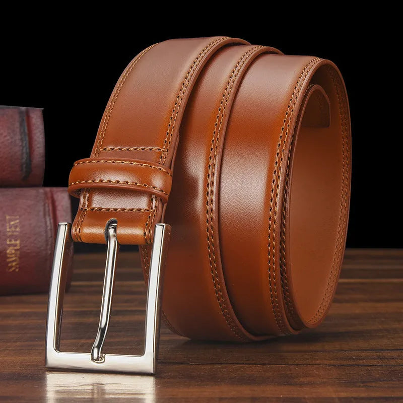 Men's black genuine leather belt with a silver alloy pin buckle fastener on a plain background