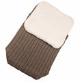 Envelope-style winter sleeping bag for a baby stroller in a neutral colour on a pushchair.
