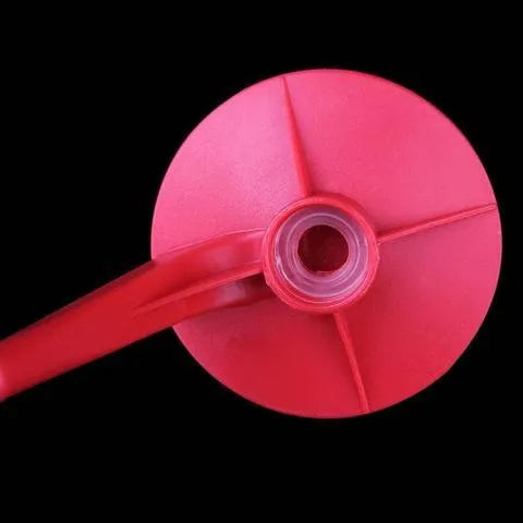 Red plastic Magic Tap soda bottle dispenser attached to a 2-litre drink bottle