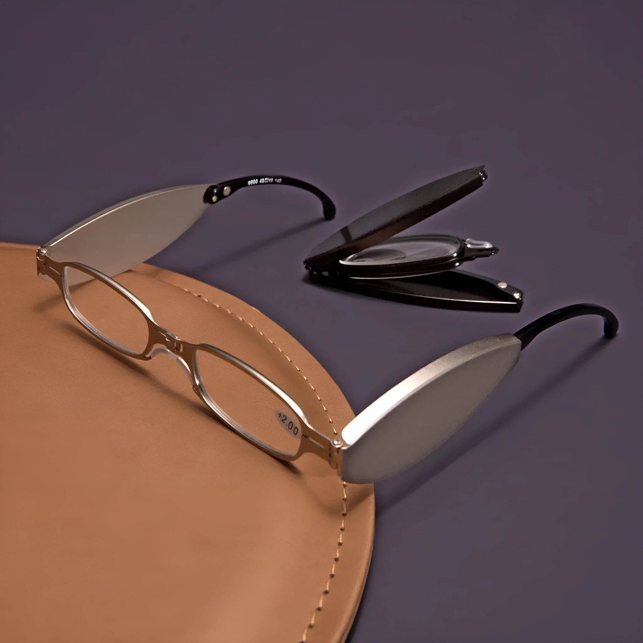 Folding pocket presbyopic glasses with retro ring-style metal frame in black or silver colour options.