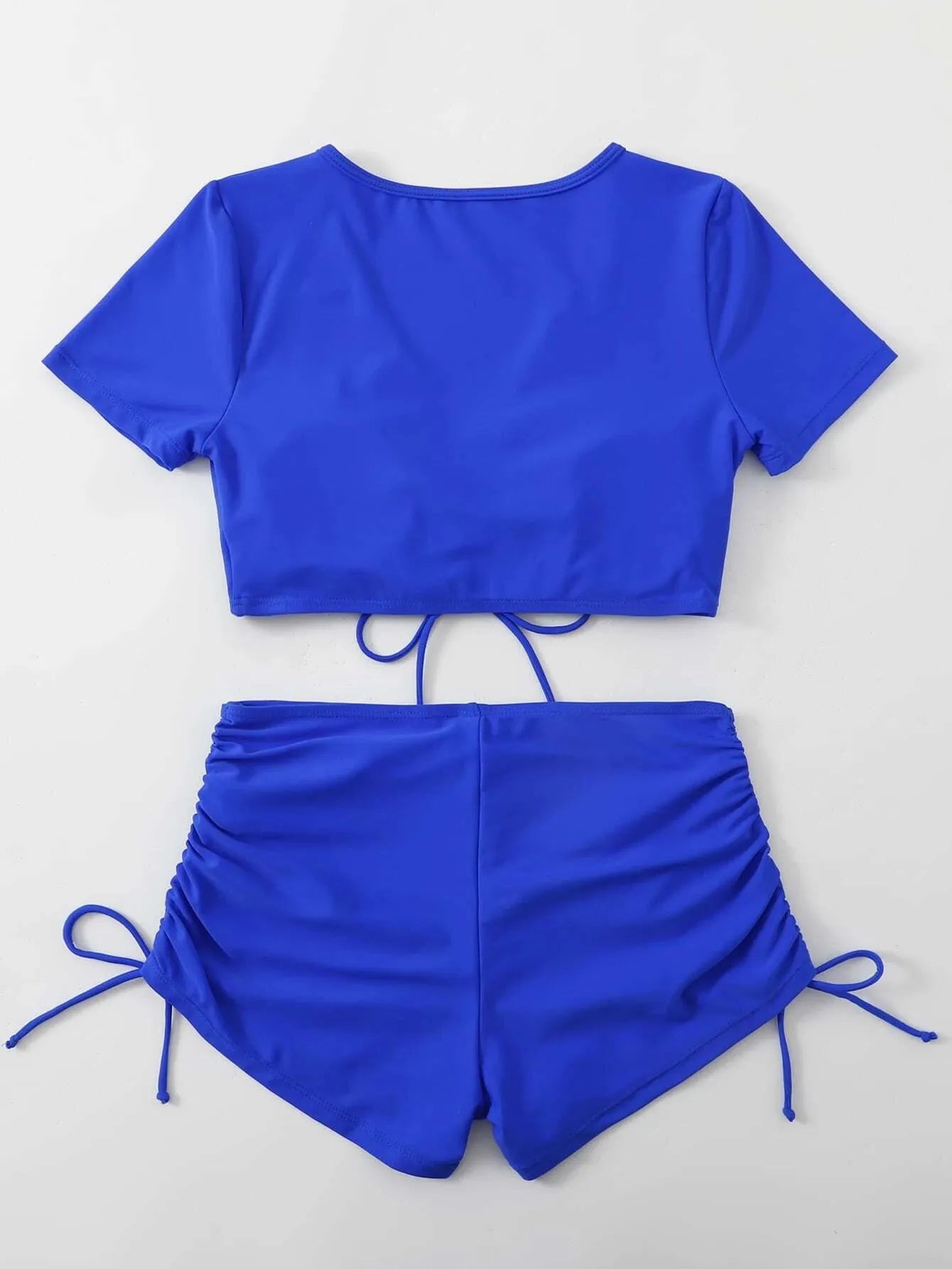 Women's two-piece swimsuit with lace-up front top and matching shorts in polyester material.