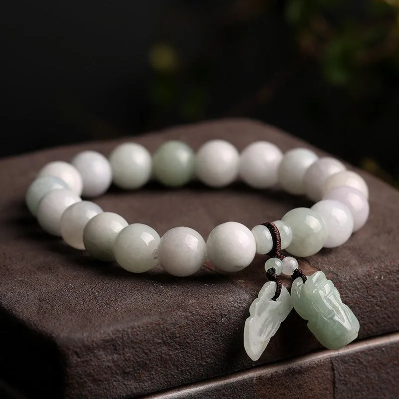 Natural emerald jade bracelet with hanging geometric beads and Buddhist elements