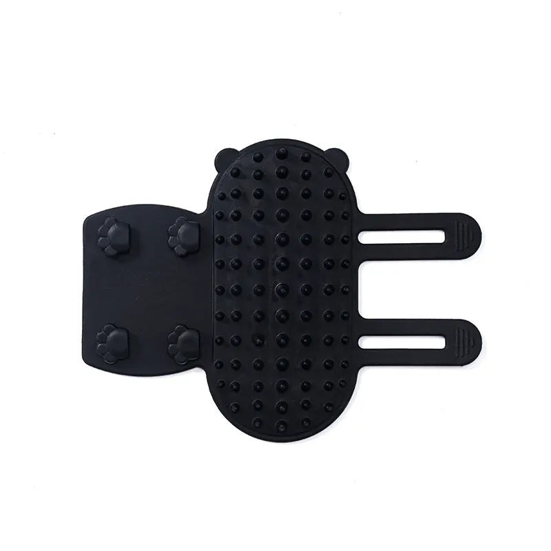 Silicone cat grooming comb with adjustable strap mounted on a table leg, shown in yellow.