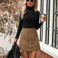 Women's high waist short skirt in black with front stitching detail and zipper.