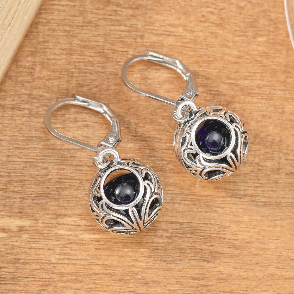 Silver geometric pendant earrings with vintage engraving and blue gemstone, shown from front view