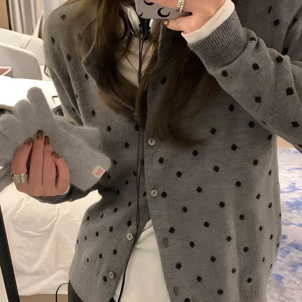 Women's grey dot knitted cardigan with crocheted flower details on sleeves, loose fit.