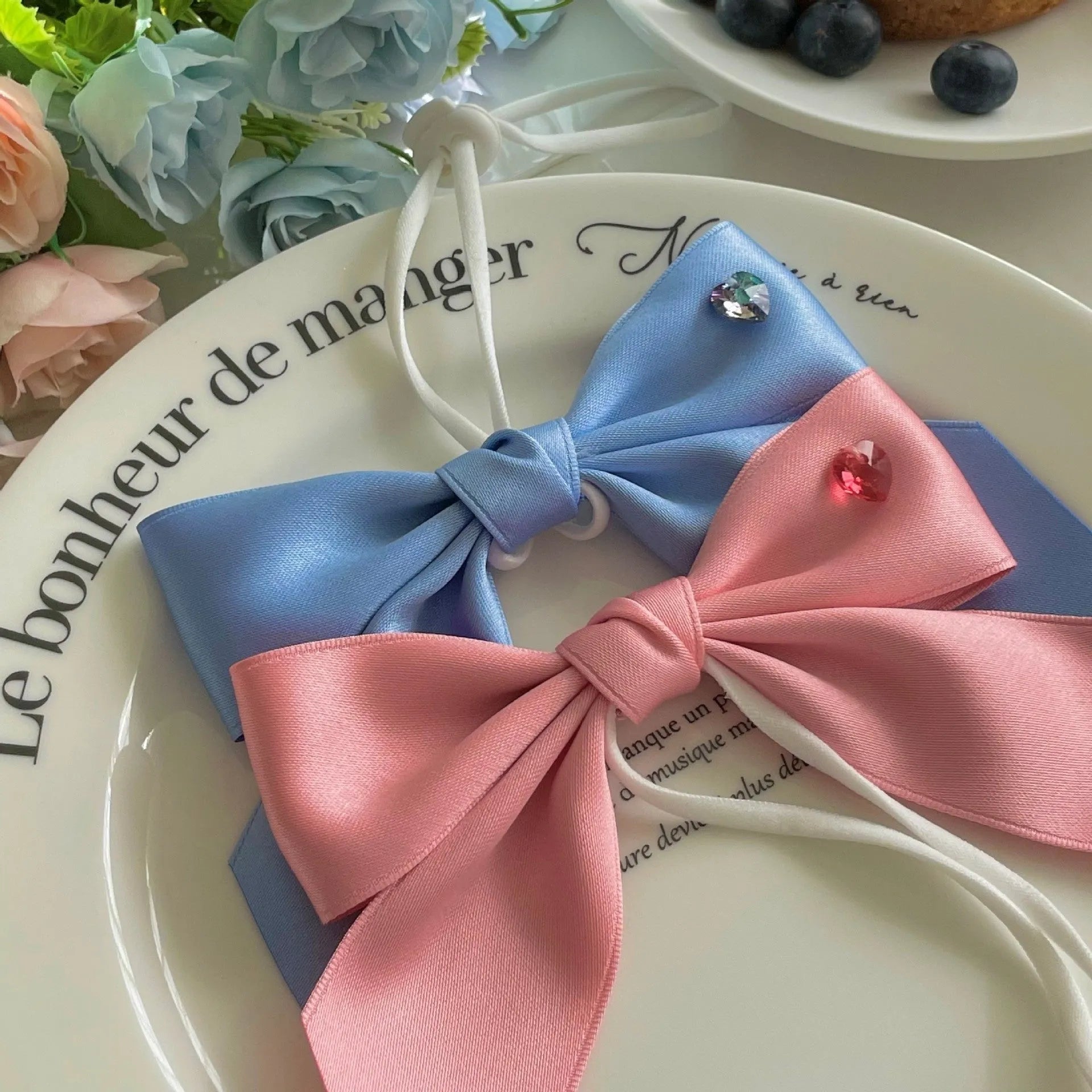Adjustable princess style dog hair band with bow decoration in blue or pink colours