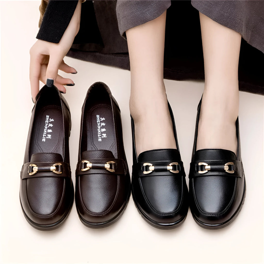 Black women's slip-on pumps with a round toe, low flat heel, and soft rubber sole.