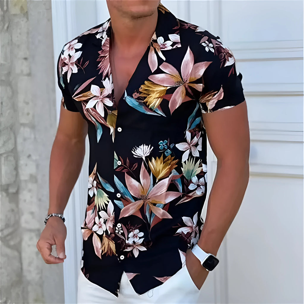 Man wearing a loose-fit short sleeve floral print shirt in a cardigan style on the beach.