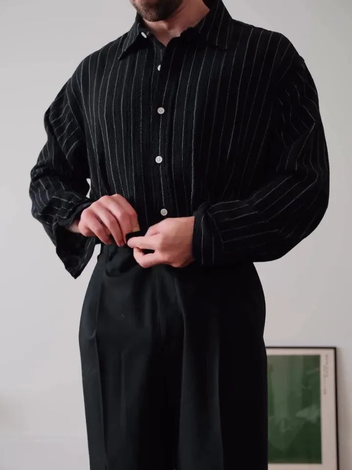 Men's black pinstriped button-down shirt with a regular fit collar on a hanger.
