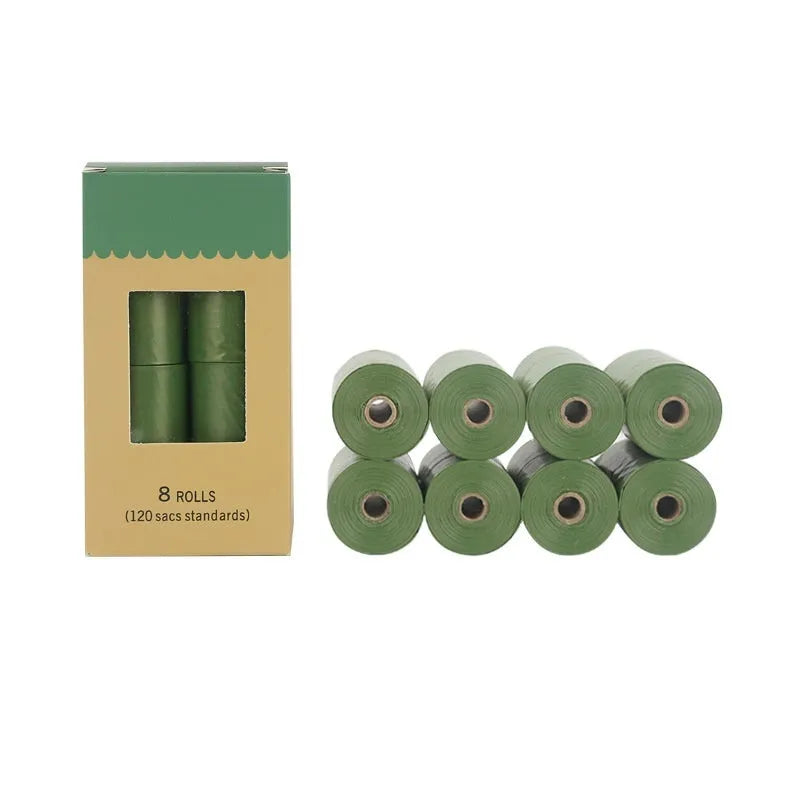 Roll of EPI degradable green dog poo bags next to a time-capsule-style dispenser on a grass background.