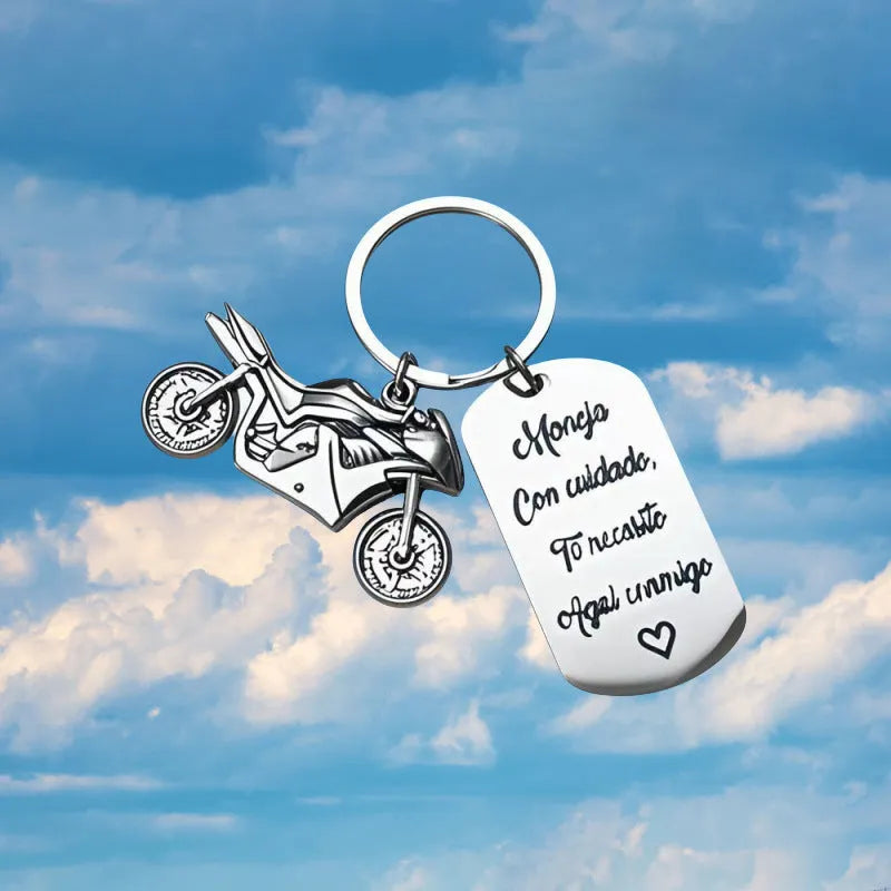 Stainless steel motorcycle key chain with modern design on velvet cloth.