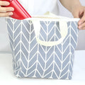 White makeup bag with a clear black arrow pattern, made from moisture-resistant polyester fabric.