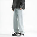 Men's light blue washed straight leg cotton jeans with a button waist closure, laid flat.