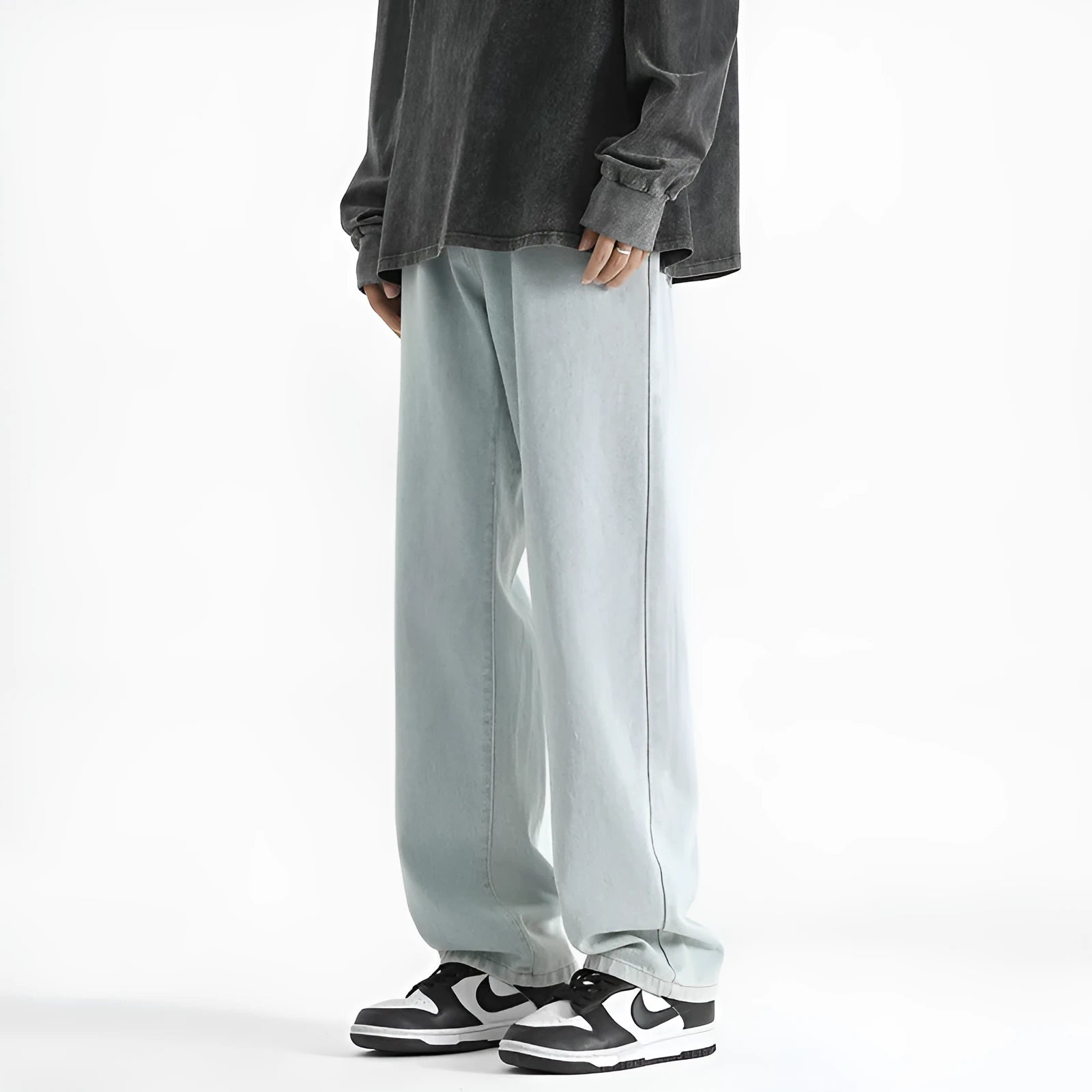 Men's light blue washed straight leg cotton jeans with a button waist closure, laid flat.