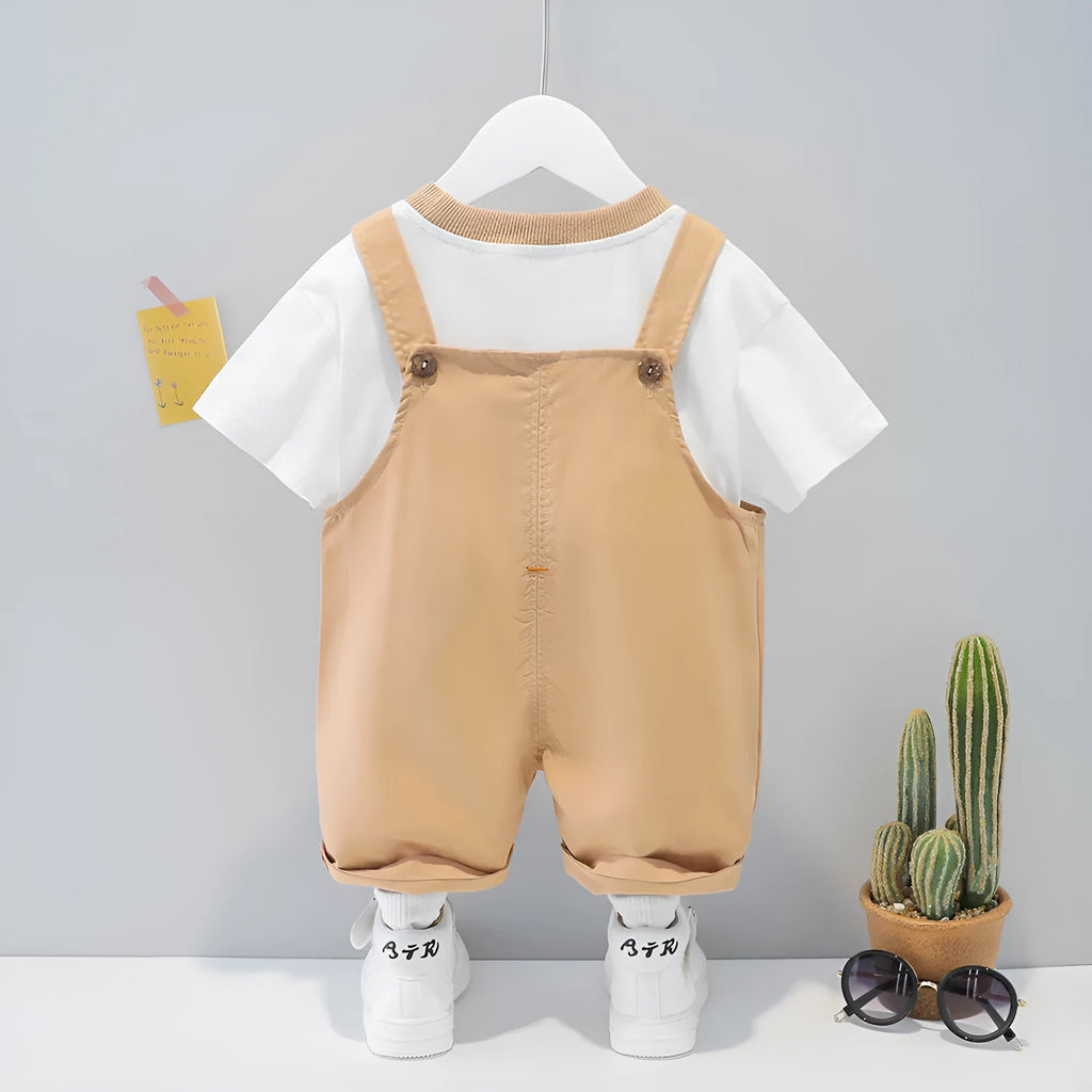 Baby wearing yellow cotton summer overalls with cartoon pattern and front buttons