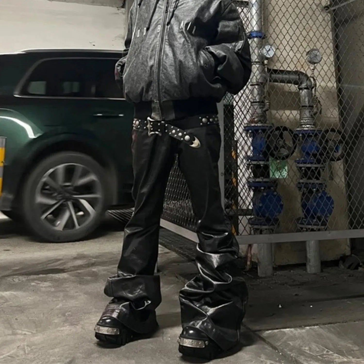 Black coated patent leather straight-leg skinny jeans on a model
