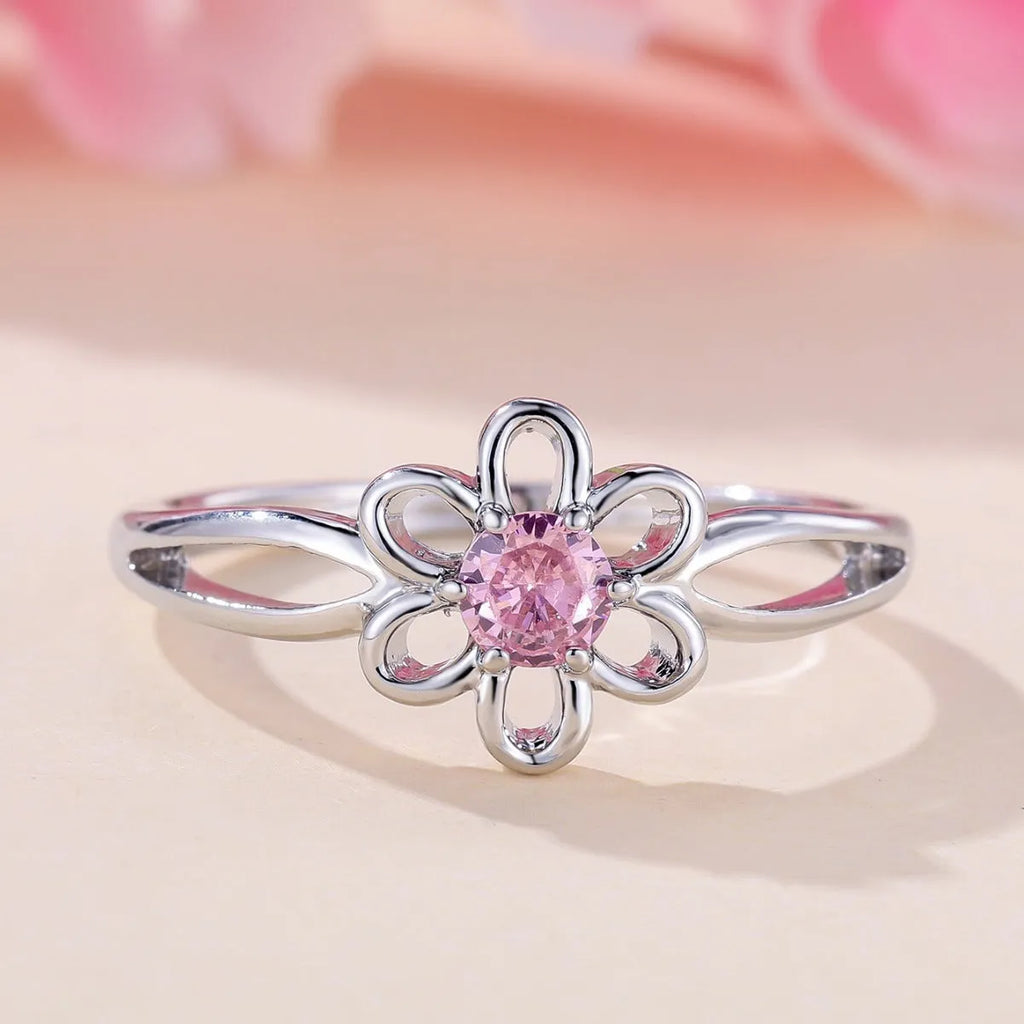 Ladies floral hollow-out fashion ring in white gold powder finish showing detailed openwork pattern
