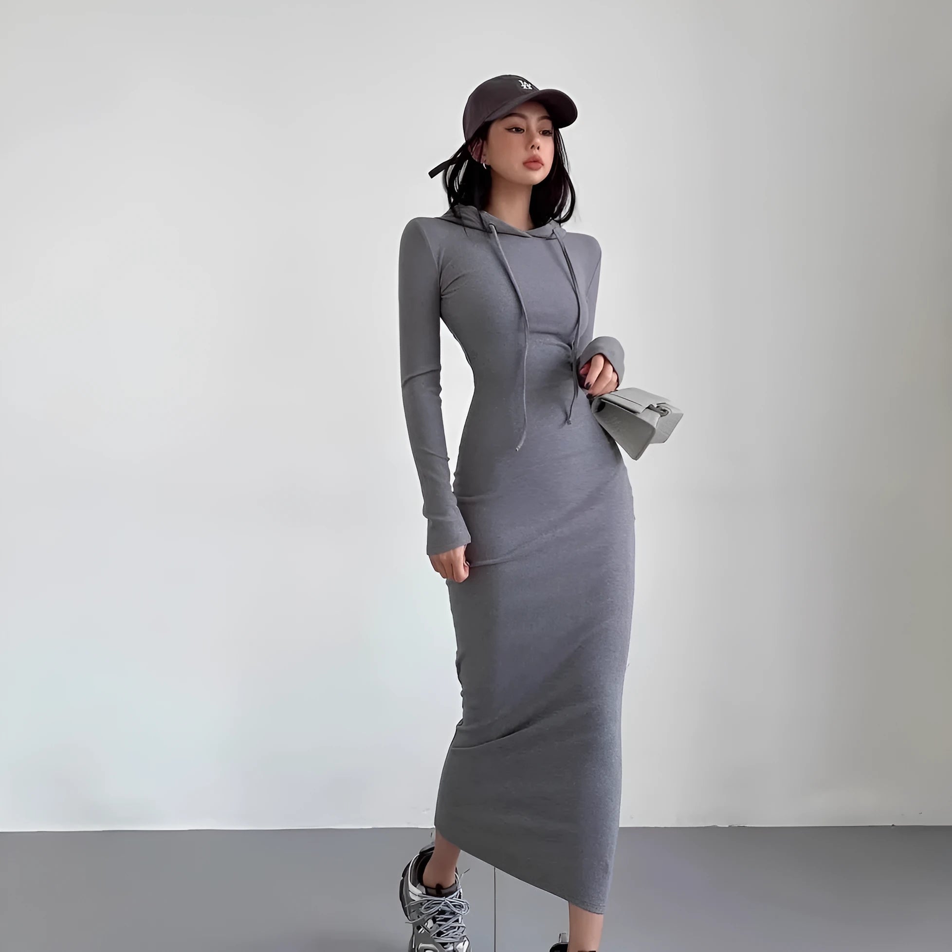 A woman's grey hooded long sleeve sheath dress with an over-the-knee length and high waist.