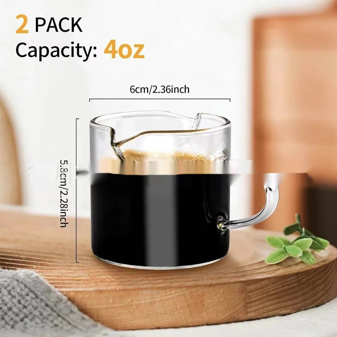 White transparent double-mouthed glass coffee cups showing two drinking openings