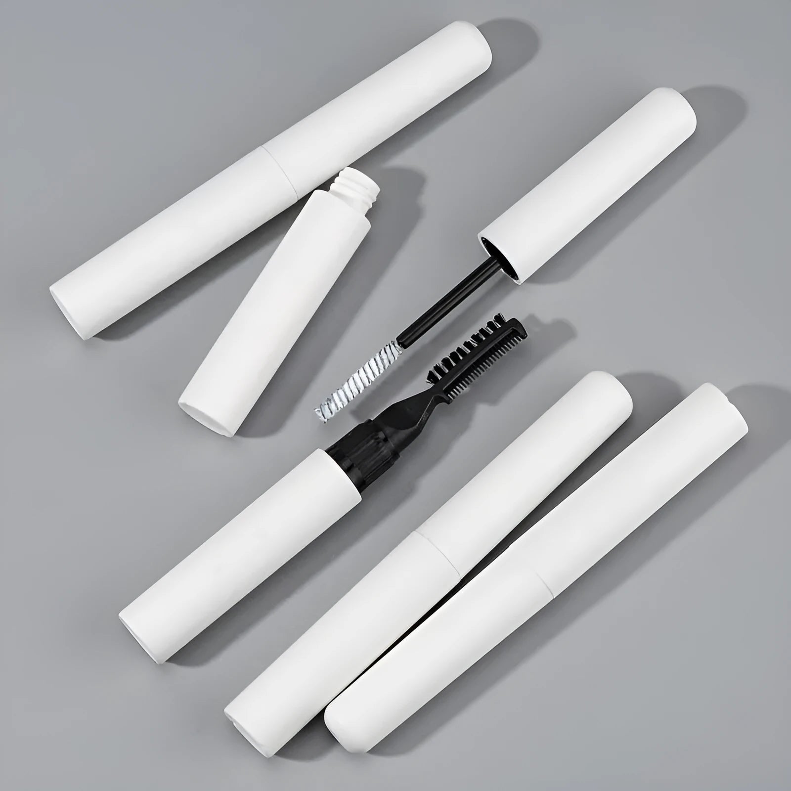Eyebrow glue bottle with applicator brush for natural wild brow styling in pink and white options.