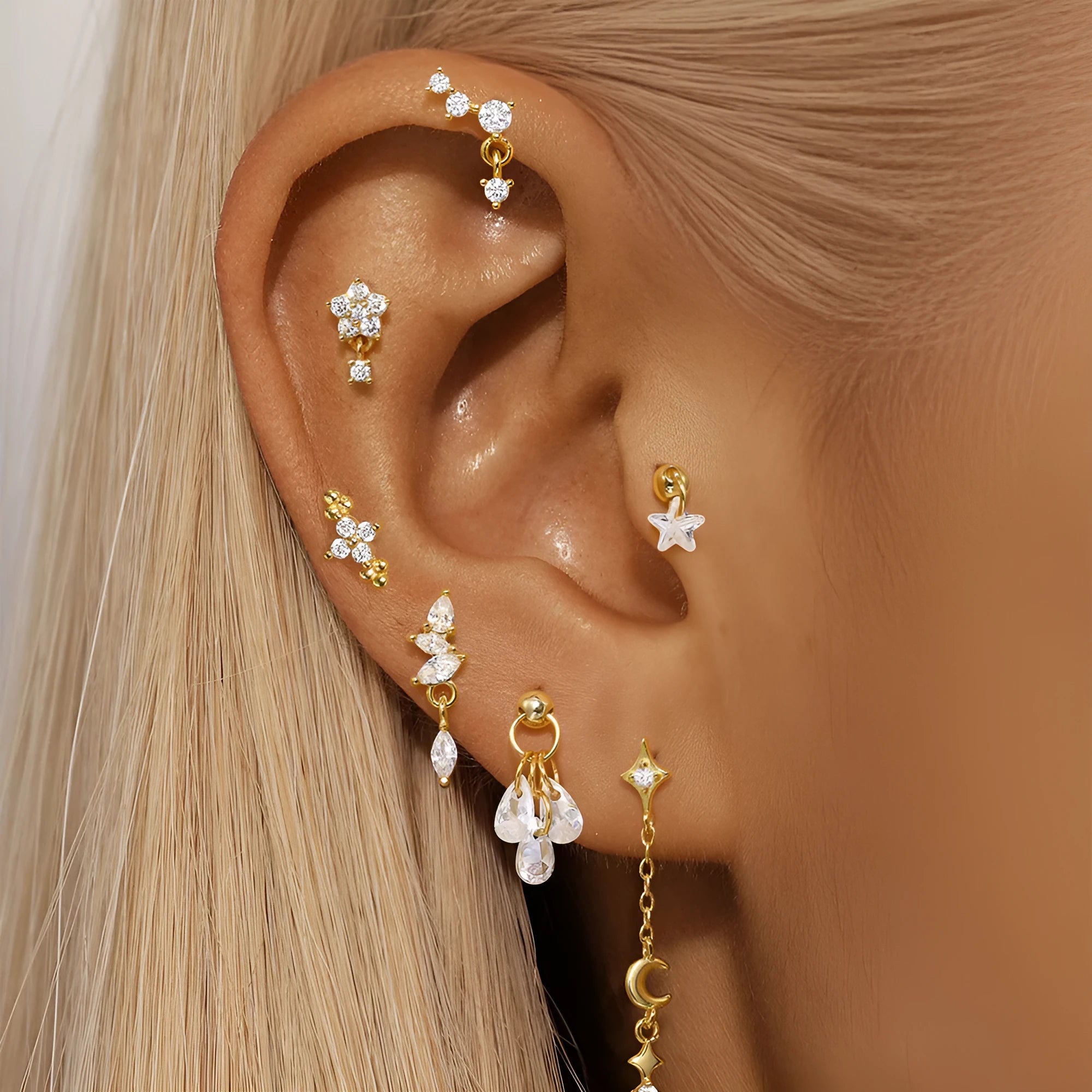 S925 sterling silver moon and star shaped earrings with embedded diamond details in a gold tone finish.