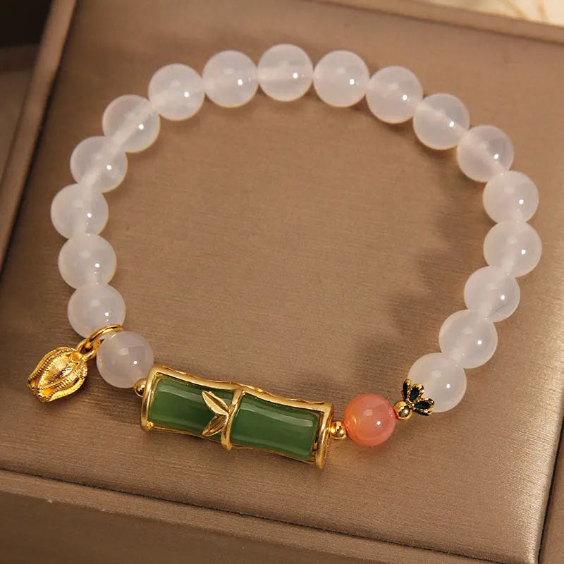 Women's Chinese style beaded bracelet with white agate centre, jade beads, and bamboo joint design.