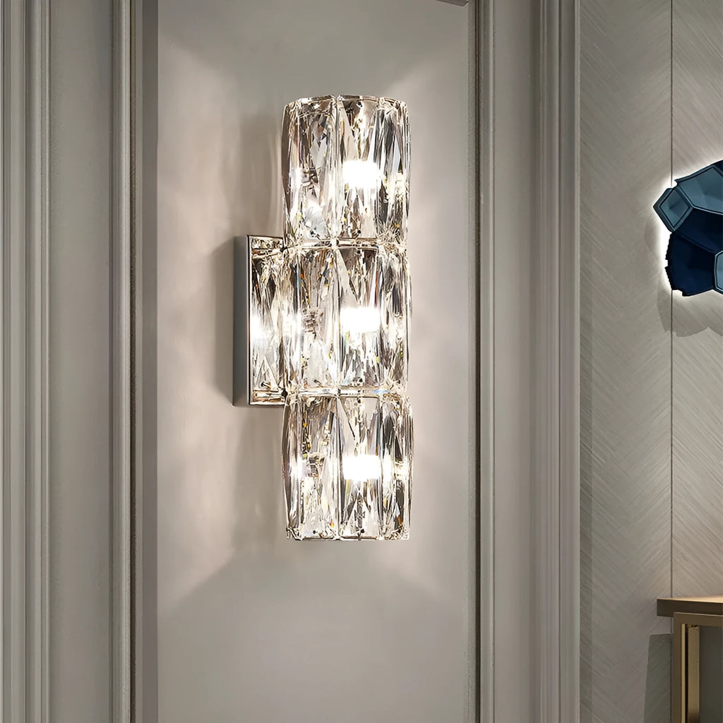 Slim crystal wall lamp with stainless steel body in chrome or gold finish, mounted on a wall.