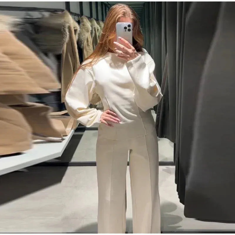 Women's black polar fleece trouser suit set with pleated long sleeve top and wide-leg pants on a hanger.