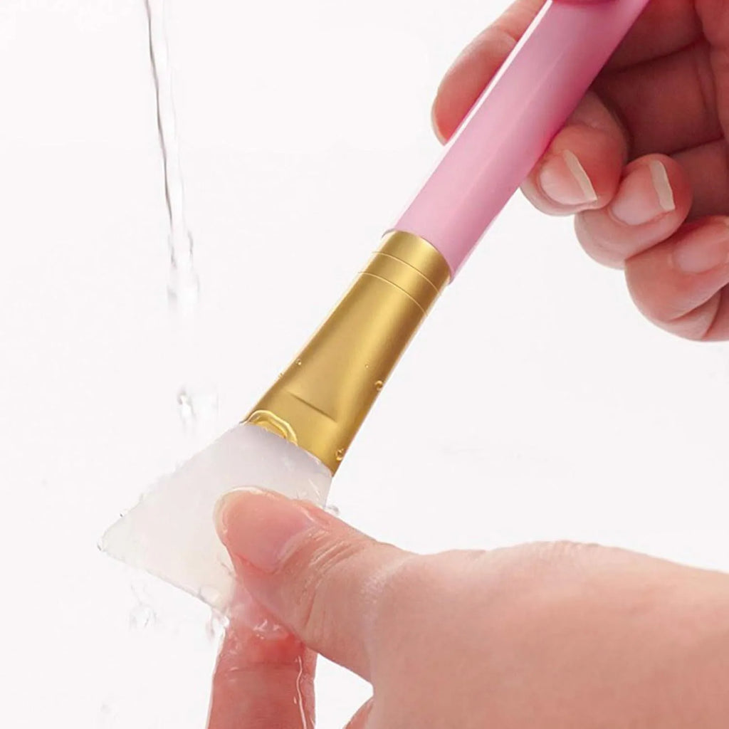 Reusable silicone spatula brush for applying clay and mud face masks, available in multiple colours.