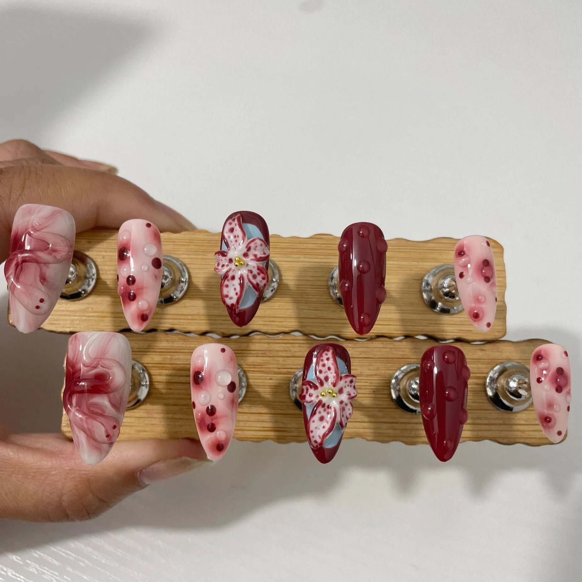 Hand-painted 3D carved manicure nail art set in almond colour with rose, tulip, and leopard print patterns