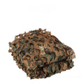 Green camouflage net set deployed as military camp cover with desert pattern visible
