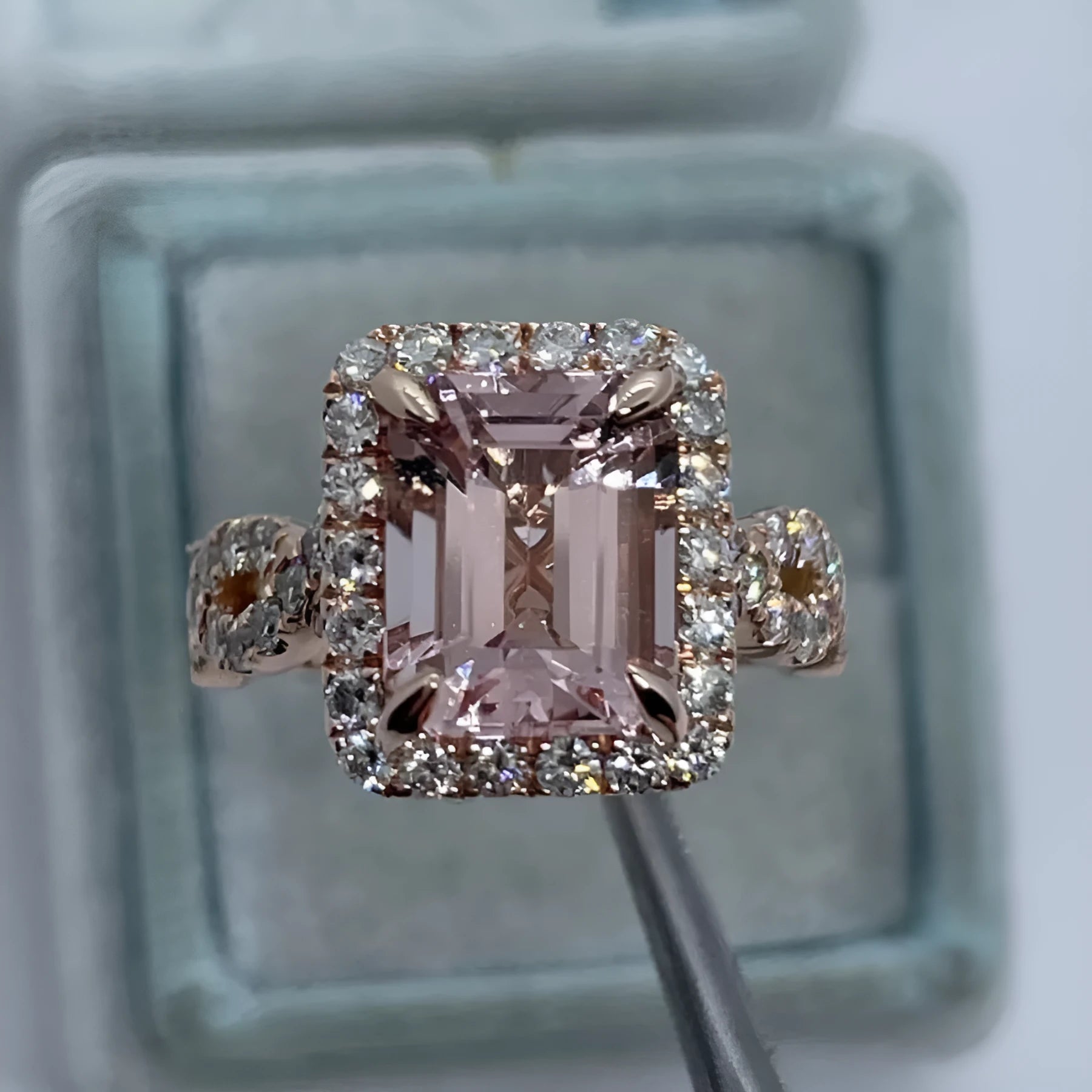 Geometric-shaped alloy ring with a rose gold electroplated finish on a neutral background.