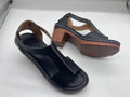 Women's plus size peep toe wedge sandals with Roman straps and a buckle in light brown.