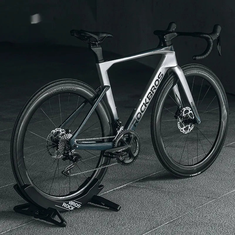 Black ABS plastic wall-mounted bike parking rack holder for road and mountain bicycles.