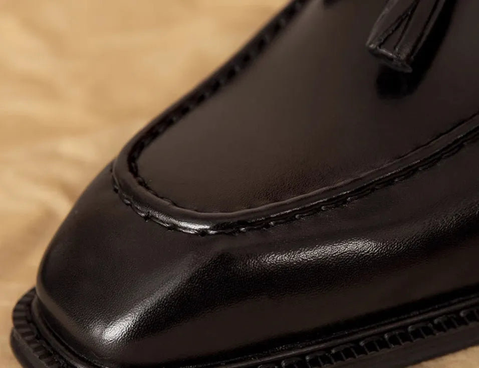 Men's black genuine leather slip-on loafers with fringed detail and rubber sole