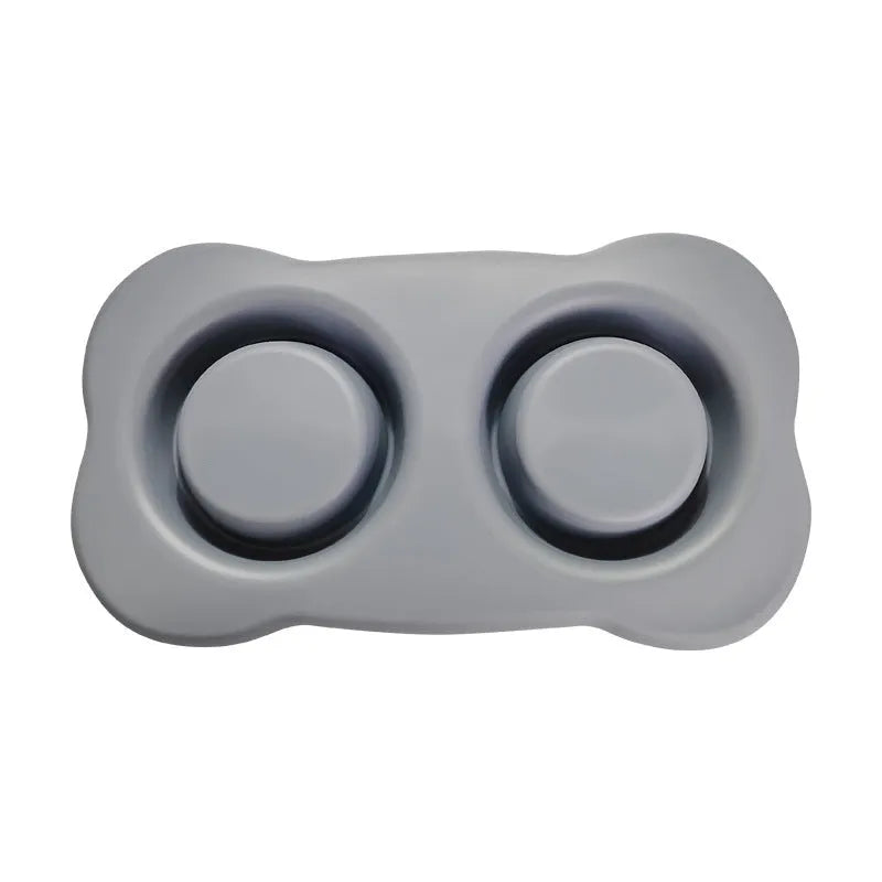Large silicone dog bowl with a stainless steel inner insert, shown in blue on a floor.