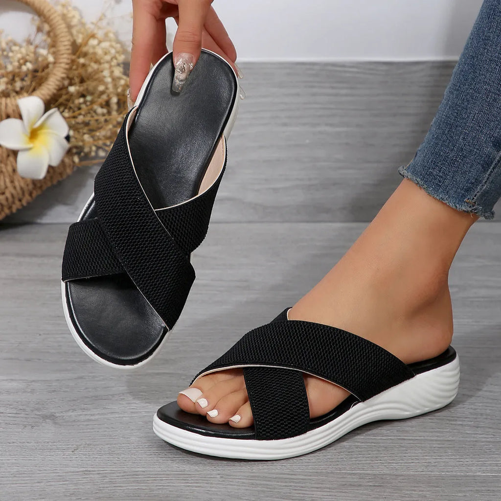 Women's black wedge slippers with peep-toe design and thick rubber sole