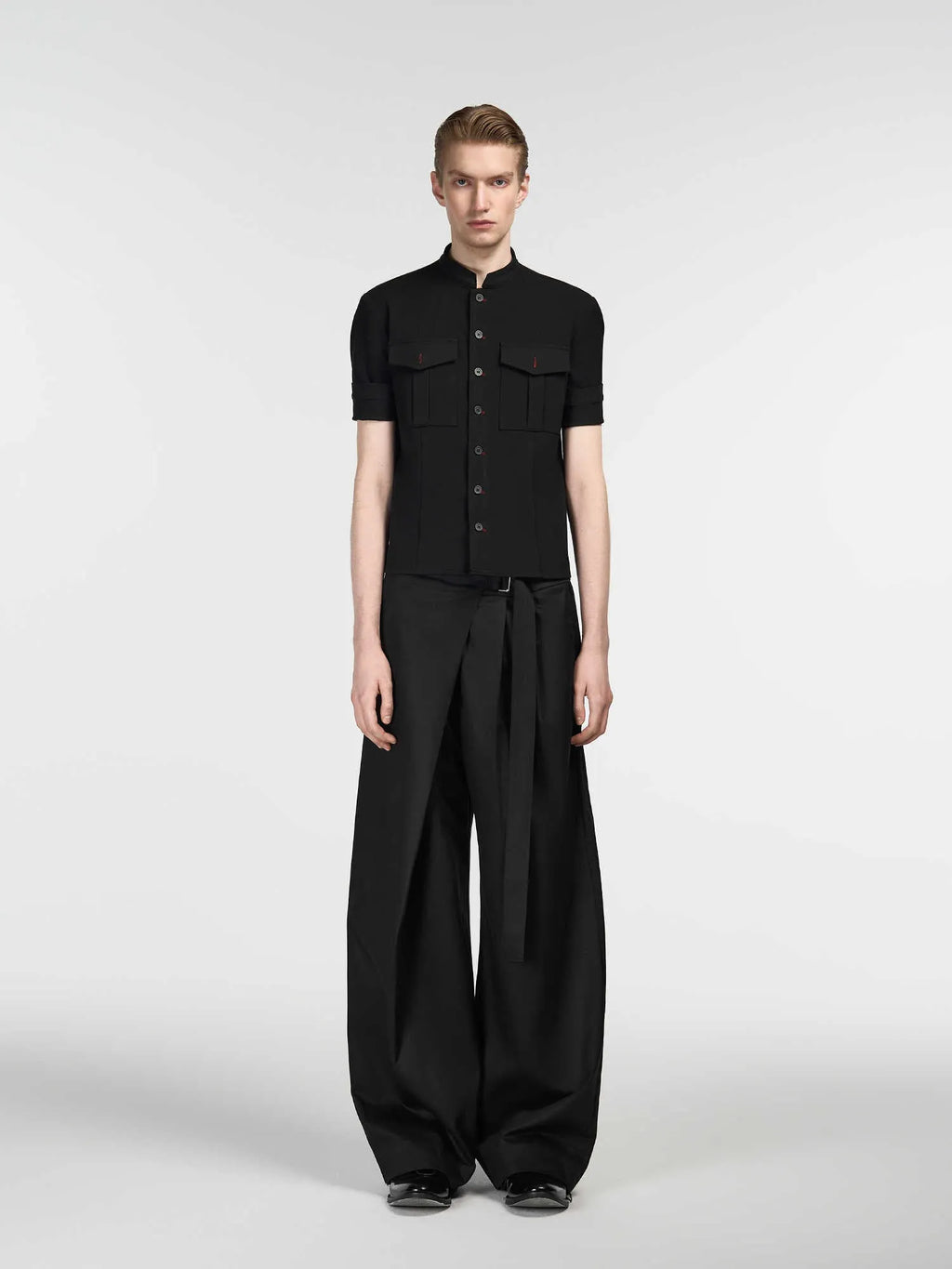 Black straight-leg women's trousers with a front pleat and adjustable waistband on a hanger.