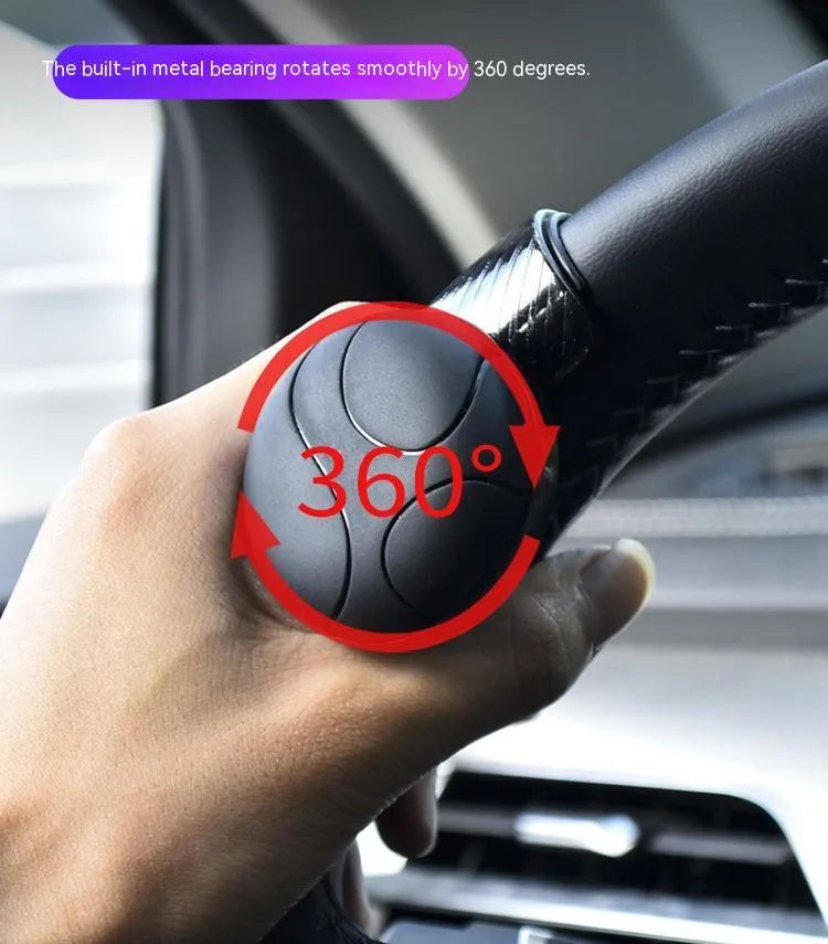 Black and blue silicone steering wheel assist ball with metal bearing booster measuring 9x6cm