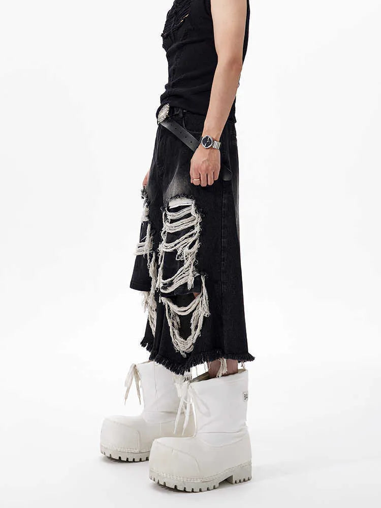 Black women's cropped wide leg jeans with ripped patch details and a mid-high waist.