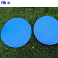 Yellow TPE football training marker disc lying flat on grass, 23cm diameter.