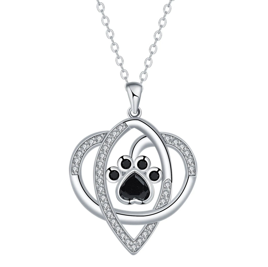 Light gold necklace with a pendant showing raised dog and cat paw prints on a cross chain.