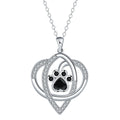 Light gold necklace with a pendant showing raised dog and cat paw prints on a cross chain.