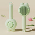 Green self-cleaning pet grooming brush with stainless steel comb and a release button on the handle.