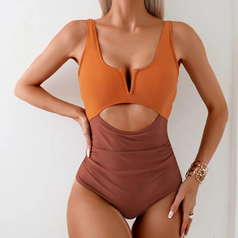 Women's one-piece swimsuit in a contrast colour design, shown in green, black, dark pink, or brown.