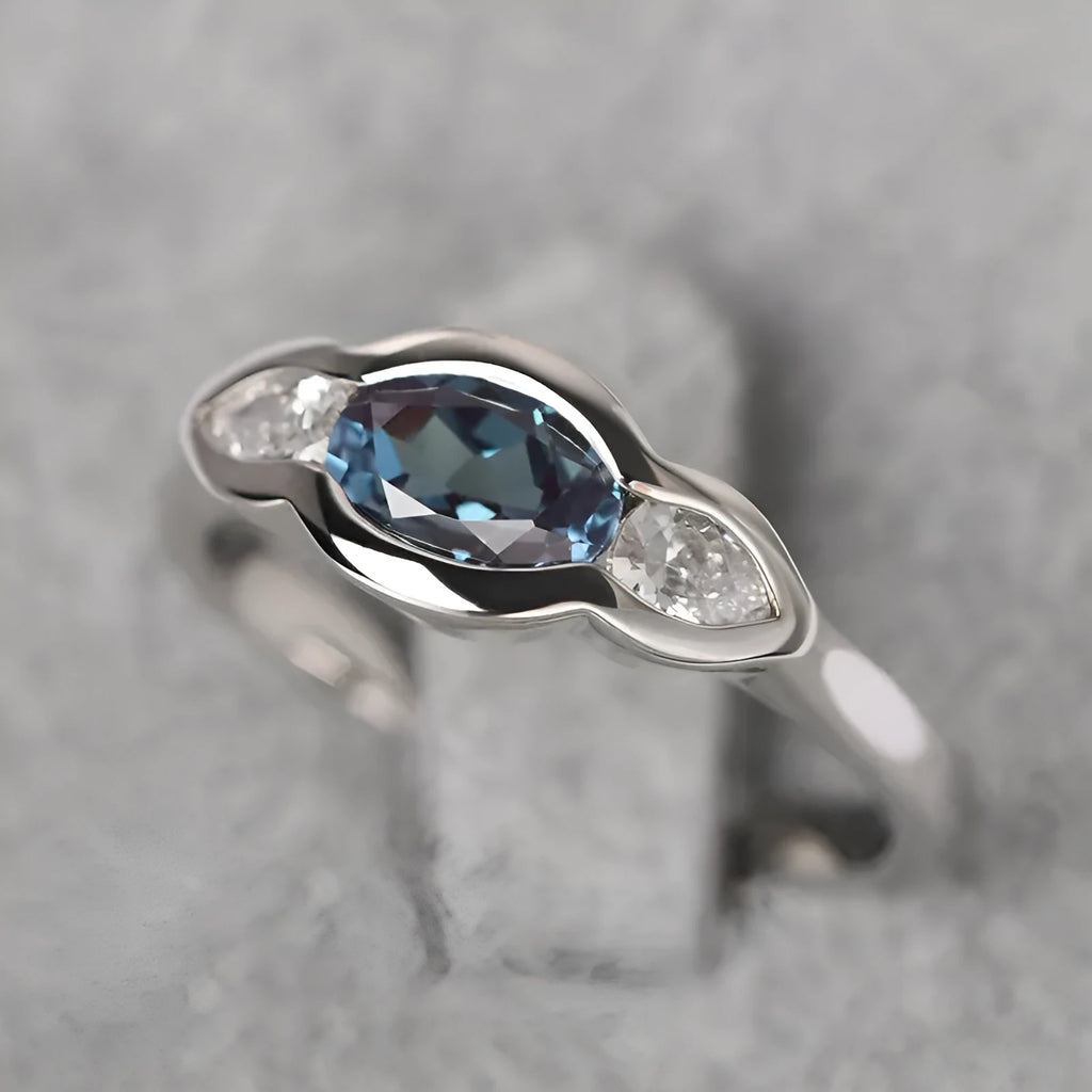 Geometric ellipse zircon ring in white gold colour showing structured design and stone inlay
