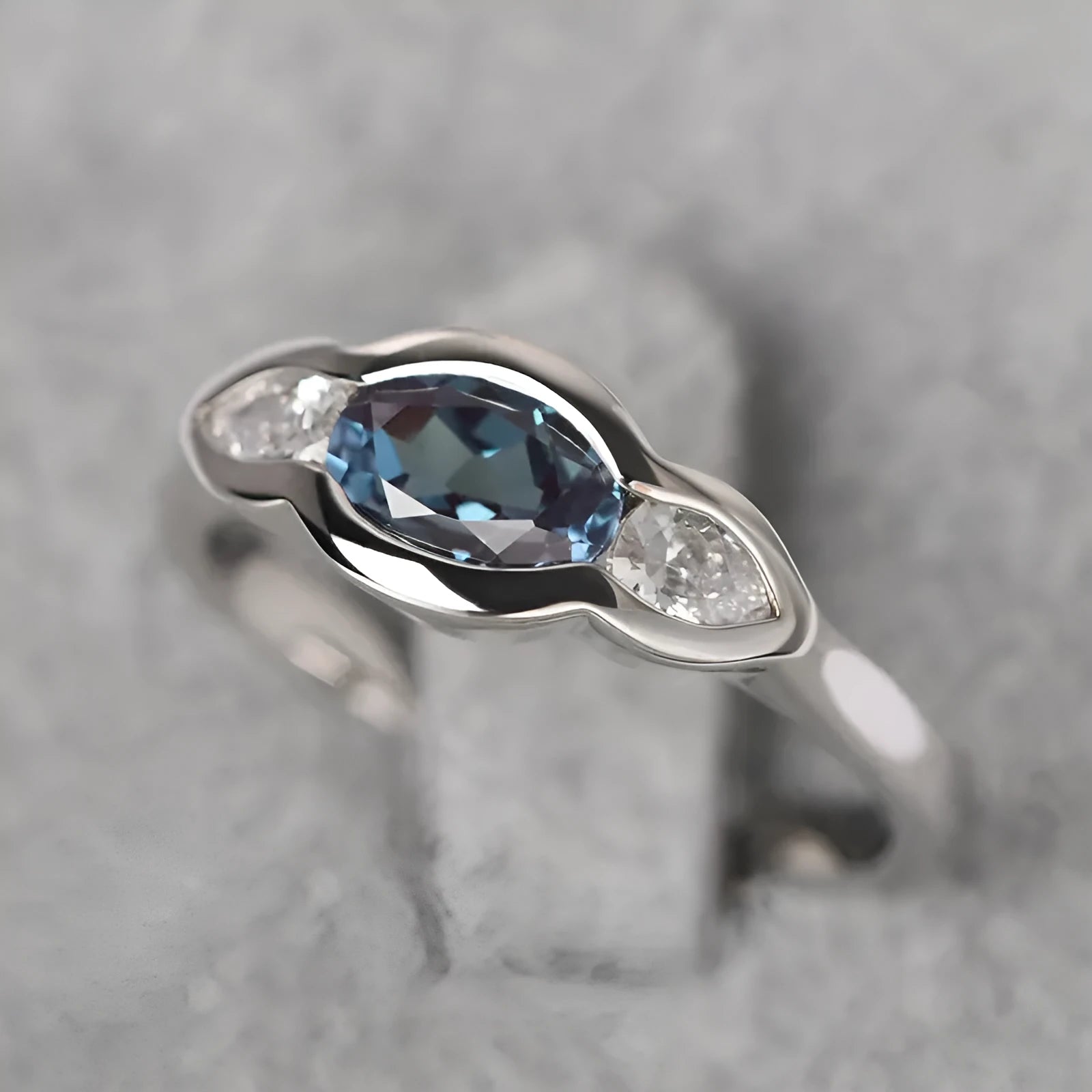 Geometric ellipse zircon ring in white gold colour showing structured design and stone inlay